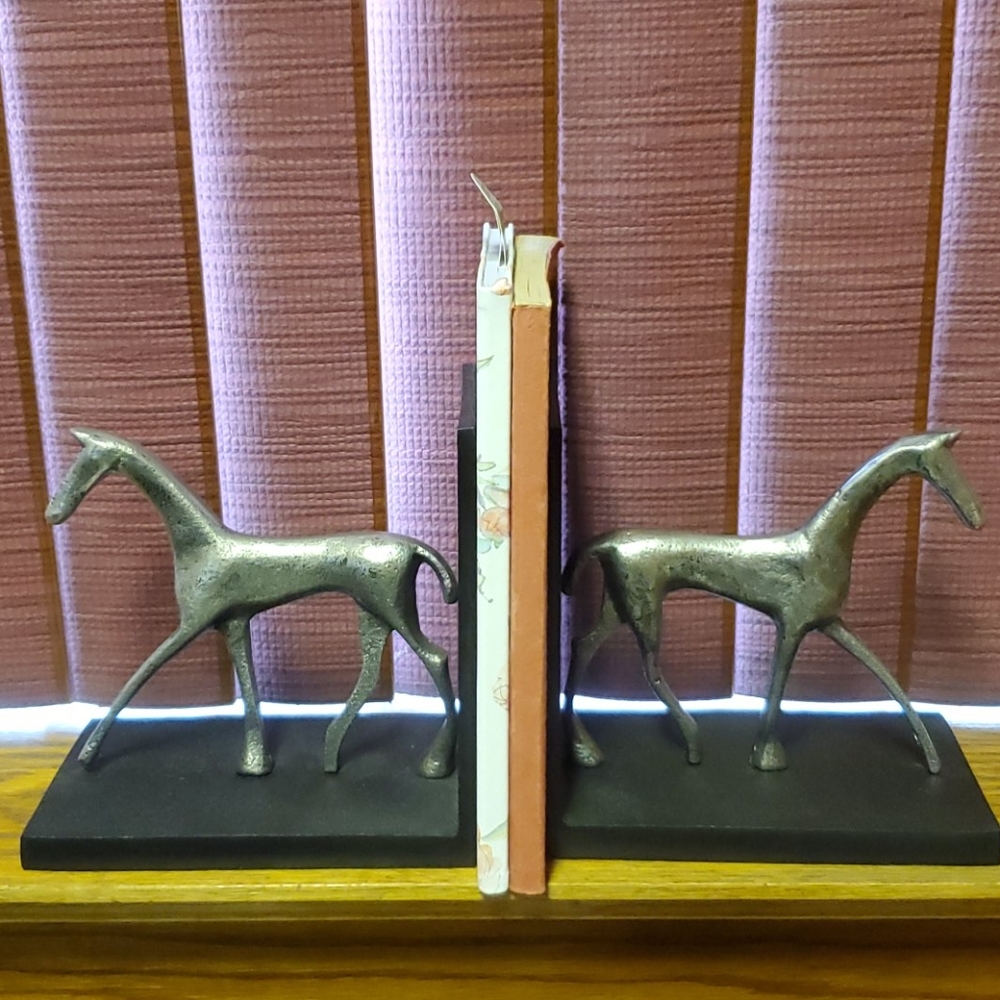 Book ends with horse sculpture.